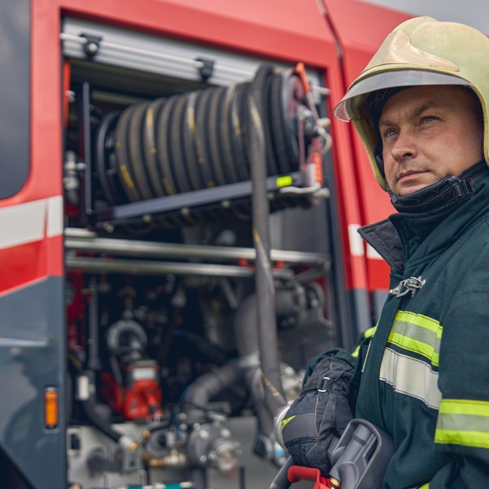 firefighter-is-standing-near-the-fire-truck-e1697420582678.jpg