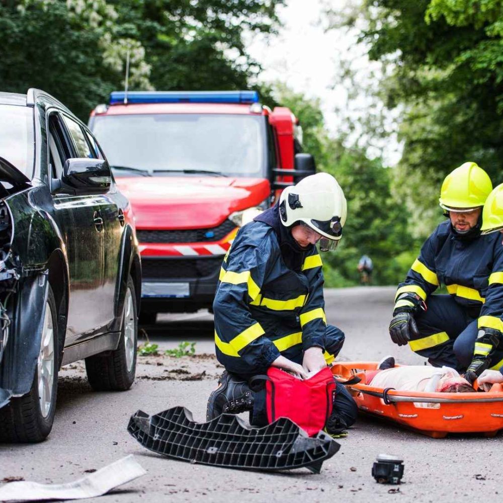 firefighters-helping-a-young-injured-woman-after-a-car-accident-image-E5YDZG3.jpeg